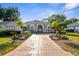 Beautiful single-Gathering home featuring a well-manicured lawn, mature trees, and a grand entrance at 2187 Calusa Lakes Blvd, Nokomis, FL 34275