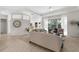 Open-concept living room with neutral tones, abundant natural light, and comfortable seating arrangement at 2187 Calusa Lakes Blvd, Nokomis, FL 34275