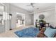 Open-concept living area with a view of the kitchen and dining area, natural light and ceiling fan at 2187 Calusa Lakes Blvd, Nokomis, FL 34275