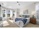 Airy bedroom featuring neutral walls, a ceiling fan, bay windows, and a lavish bed with stylish cushions at 2187 Calusa Lakes Blvd, Nokomis, FL 34275
