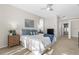 Sunlit bedroom featuring an elegant bed with soft pillows, a ceiling fan, and two dressers providing ample storage at 2187 Calusa Lakes Blvd, Nokomis, FL 34275