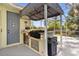 Outdoor kitchen with a grill, food prep station, sink, and convenient toilet access at 2187 Calusa Lakes Blvd, Nokomis, FL 34275