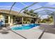Sparkling pool, screened lanai, outdoor kitchen with grill, and comfortable seating area at 2187 Calusa Lakes Blvd, Nokomis, FL 34275