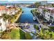 Beautiful aerial view overlooking a canal with a dock and waterfront condominium community with a courtyard and outdoor seating at 230 Santa Maria St # 333, Venice, FL 34285