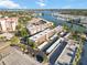 Aerial view showcasing waterfront condo community, including covered parking and the surrounding area at 230 Santa Maria St # 333, Venice, FL 34285