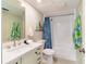 Well-lit bathroom featuring a updated sink, shower with curtain, and fresh decor at 230 Santa Maria St # 333, Venice, FL 34285