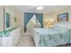 Light and bright bedroom with updated flooring, a queen-sized bed, and tropical bedding at 230 Santa Maria St # 333, Venice, FL 34285