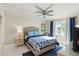 Comfortable bedroom with blue accents, ceiling fan, and bright window provides natural light at 230 Santa Maria St # 333, Venice, FL 34285