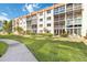 Exterior view of building with screened in porches and lush landscaping at 230 Santa Maria St # 333, Venice, FL 34285