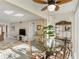 Open dining area features a glass table, designer fan, and stylish furniture, seamlessly connecting to the living room at 230 Santa Maria St # 333, Venice, FL 34285