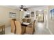 Cozy dining room with a glass table, tropical-themed chairs, and view to the kitchen at 230 Santa Maria St # 333, Venice, FL 34285