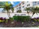 Well-maintained landscape featuring the community sign 'Bella Costa' at 230 Santa Maria St # 333, Venice, FL 34285