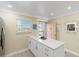 Well-lit kitchen featuring white cabinets, stainless steel appliances, quartz countertops, and access to the outside balcony at 230 Santa Maria St # 333, Venice, FL 34285