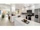 Modern kitchen with white cabinetry, quartz countertops, stainless steel appliances, and an opening to the dining room at 230 Santa Maria St # 333, Venice, FL 34285