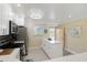 Updated kitchen featuring white cabinetry, quartz countertop island, stainless steel appliances, and a view of the outside at 230 Santa Maria St # 333, Venice, FL 34285