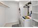 Compact laundry room with a stacked washer and dryer, and built-in shelving at 230 Santa Maria St # 333, Venice, FL 34285