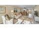 Open living room with view to dining area, comfortable seating, and tropical-themed decor at 230 Santa Maria St # 333, Venice, FL 34285
