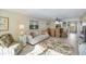 Inviting living room with sofa and tropical decor, with view to the dining room and kitchen at 230 Santa Maria St # 333, Venice, FL 34285