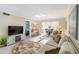 Inviting living room featuring a comfortable sofa, entertainment center, and a view to the sun room at 230 Santa Maria St # 333, Venice, FL 34285