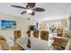 Living room featuring a glass-topped dining table, a ceiling fan, and beach-themed decor at 230 Santa Maria St # 333, Venice, FL 34285