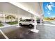Assigned parking under carport with building and landscape in background at 230 Santa Maria St # 333, Venice, FL 34285