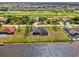 Aerial view capturing the property next to canal, backing onto a lush green golf course in a serene community at 233 Rotonda Cir, Rotonda West, FL 33947