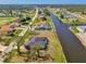 This aerial view shows the real estate property and its proximity to the canal and golf course at 233 Rotonda Cir, Rotonda West, FL 33947