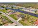 An aerial shot of a single-Gathering home featuring waterfront views, manicured landscaping, and a serene neighborhood setting at 233 Rotonda Cir, Rotonda West, FL 33947