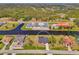 An aerial view of a residential property with water access and surrounding houses in a tranquil, scenic location at 233 Rotonda Cir, Rotonda West, FL 33947