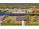 A waterfront property showcases a beautiful single-Gathering home with a scenic canal view and lush landscaping at 233 Rotonda Cir, Rotonda West, FL 33947