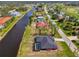 Aerial view featuring canal front property on a sprawling lot next to a lush green golf course at 233 Rotonda Cir, Rotonda West, FL 33947
