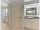 Bright bathroom with a large vanity, mirrored closet doors and neutral wall and floor coverings at 233 Rotonda Cir, Rotonda West, FL 33947