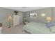 Bedroom with an armchair, a window dressed with blinds, and a bed dressed in striped bedding at 233 Rotonda Cir, Rotonda West, FL 33947