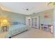 Bedroom with white storage, a desk, and bed dressed in neutral bedding, and bright striped coverlet at 233 Rotonda Cir, Rotonda West, FL 33947