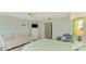 Bright bedroom with a bed dressed in floral bedding, white furnishings, and light blue walls at 233 Rotonda Cir, Rotonda West, FL 33947