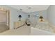 Bedroom boasts a chair, ceiling fan, dresser with many drawers and closet access at 233 Rotonda Cir, Rotonda West, FL 33947