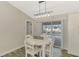 Cozy dining area with a charming white table and chairs, and backyard views at 233 Rotonda Cir, Rotonda West, FL 33947
