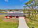 The beautiful one story home has mature landscaping, a long driveway and an attached two car garage at 233 Rotonda Cir, Rotonda West, FL 33947