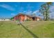 This single-story residence boasts fresh landscaping and an inviting exterior and long drive at 233 Rotonda Cir, Rotonda West, FL 33947
