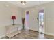 Bright foyer featuring wood-look flooring, decorative table, and door with decorative glass at 233 Rotonda Cir, Rotonda West, FL 33947