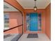 Inviting entryway with a vibrant blue door, decorative glass, and stylish lighting at 233 Rotonda Cir, Rotonda West, FL 33947