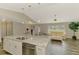 Bright and airy living room and kitchen featuring granite countertops, modern appliances, and open floor plan at 233 Rotonda Cir, Rotonda West, FL 33947