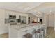 Contemporary kitchen features a marble island, stainless steel appliances, and stylish backsplash at 233 Rotonda Cir, Rotonda West, FL 33947