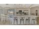 Updated kitchen with stainless steel appliances, an island with seating, and backyard access at 233 Rotonda Cir, Rotonda West, FL 33947