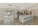 Eat-in kitchen boasts an island with counter seating, stainless appliances, and bright lighting at 233 Rotonda Cir, Rotonda West, FL 33947