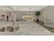 Bright living room featuring comfortable seating and a view from the kitchen island with granite countertops at 233 Rotonda Cir, Rotonda West, FL 33947
