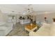 Open-concept living room and kitchen area featuring vaulted ceilings and updated flooring at 233 Rotonda Cir, Rotonda West, FL 33947