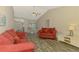 Open-concept living area with vaulted ceiling, wood-look floors, and plenty of natural light at 233 Rotonda Cir, Rotonda West, FL 33947