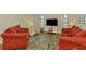 Inviting living room featuring two comfortable sofas, modern flooring, and abundant natural light at 233 Rotonda Cir, Rotonda West, FL 33947