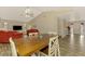 Open-concept living room and dining area featuring vaulted ceilings and wood-look floors at 233 Rotonda Cir, Rotonda West, FL 33947